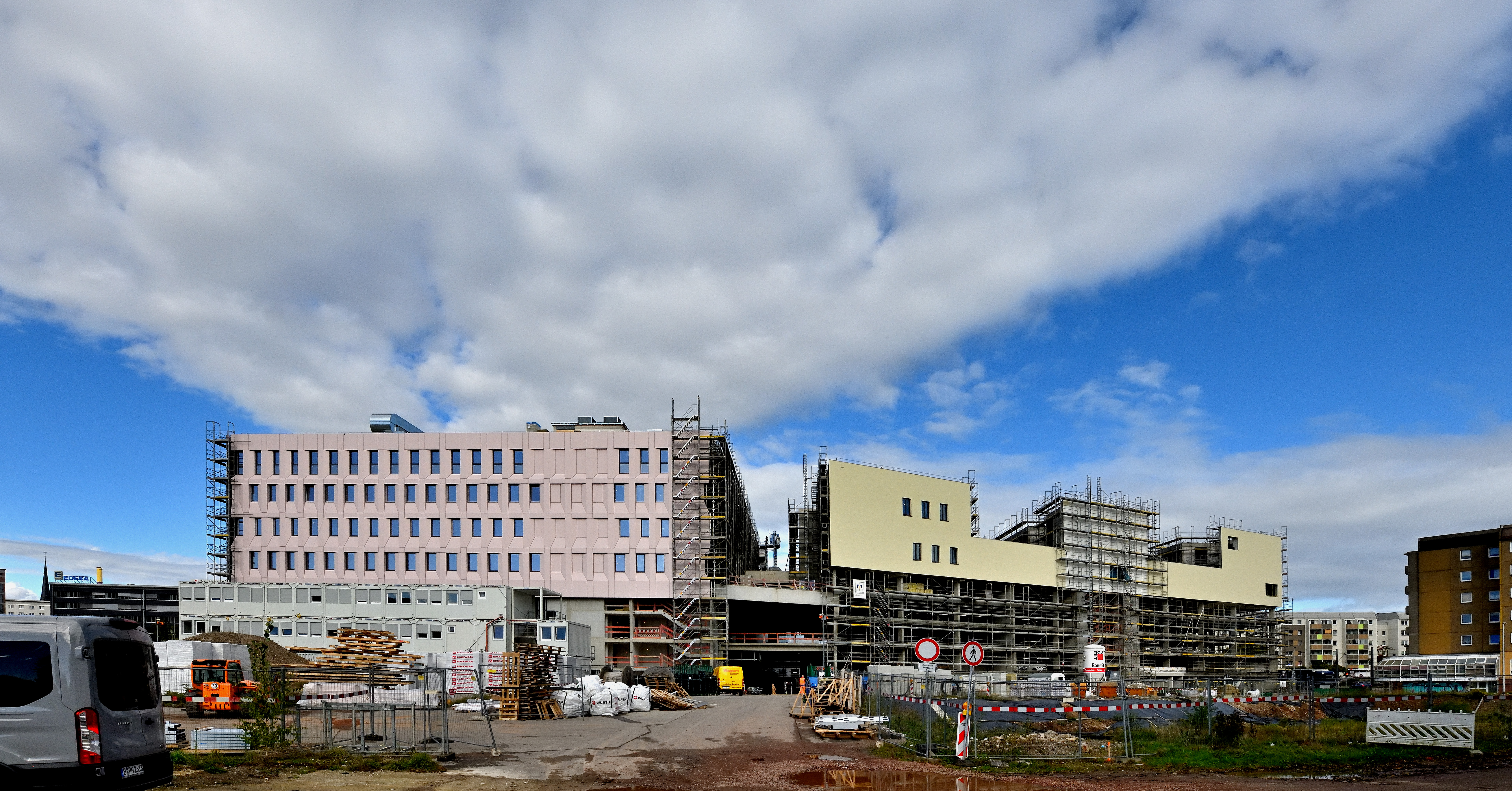 Die Gerüste auf der Südseite dürfen langsam abgebaut werden. Die Baukörperkonstellation mit auf dem Parkhausockel aufgesetztem Baukörper für die Stadthäuser wird erkennbar. In Ebene 7 werden die Gärten und ein Spielplatz für die Stadthäuser angelegt.